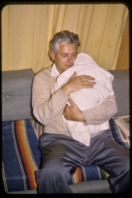 Reynold Brown holding newest daughter 1956